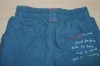 Modré šusťákové oteplené kalhoty s nápisy zn. Mothercare
