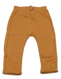 Oranžovobéžové tepláky Tu