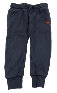 Tmavomodré tepláky s výšivkou Next