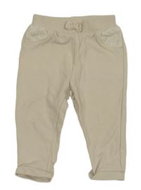 Béžové tepláky s madeirou a mašlí C&A