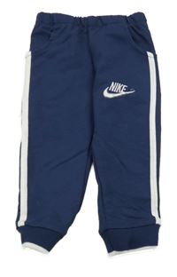 Tmavomodré tepláky s pruhem a logem - Nike
