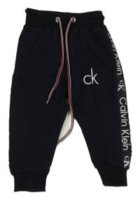 Tmavomodré tepláky s logy a pruhem Calvin Klein
