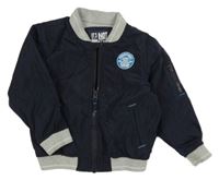 Tmavomodrá šusťáková zateplená bunda s nášivkou Mothercare