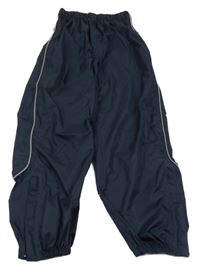 Tmavomodré šusťákové nepromokavé kalhoty TCM