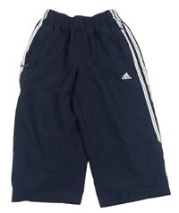 Tmavomodré šusťákové capri kalhoty s logem zn. Adidas