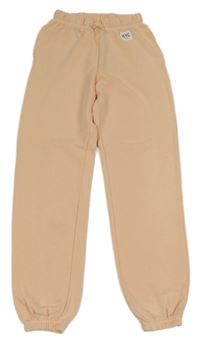 Meruňkové tepláky s nášivkou H&M