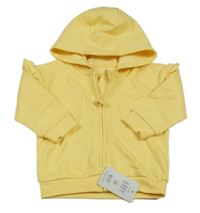 Nové - Žlutá propínací mikina s volánky a kapucí George