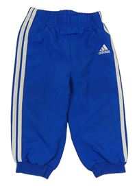 Modré šusťákové podšité kalhoty s logem Adidas