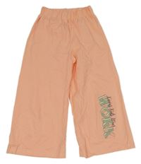 Světleoranžové široké slabé crop tepláky s nápisy 