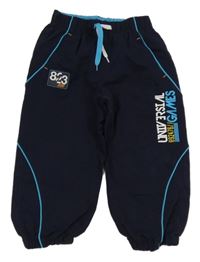 Tmavomodré šusťákové podšité kalhoty s nápisy a nášivkou Rebel