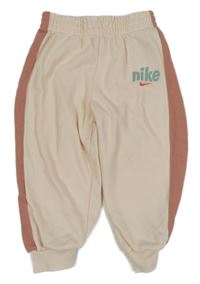 Pudrovo-růžové tepláky s logem Nike 