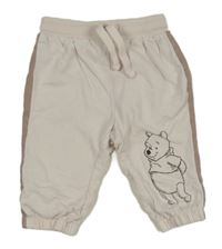 Bílo-béžové tepláky s Medvídkem Pú Disney