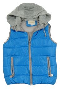 Modrá prošívaná šusťáková zateplená vesta s odepínací kapucí