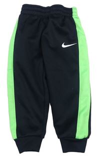 Černo-neonově zelené sportovní funkční tepláky s logem Nike