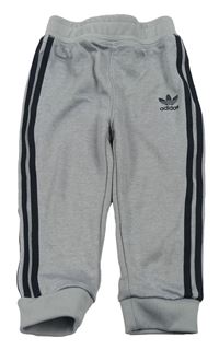 Světlešedé sportovní tepláky s logem Adidas