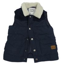 Tmavomodrá šusťáková zateplená vesta s huňatým límcem Matalan