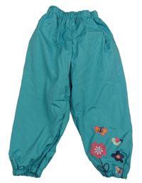 Modrozelené šusťákové nepromokavé podšité kalhoty s kytičkami a motýlky a ptáčkem