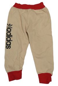 Béžovo-červené tepláky s logem Adidas