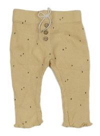 Béžové vzorované tepláky s ťapičkami Kiabi