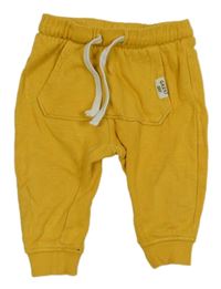 Žluté tepláky s nášivkou H&M