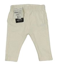 Nové - Smetanové legíny s volánky 