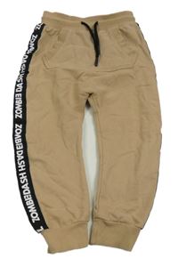 Pískové tepláky s pruhem s nápisy