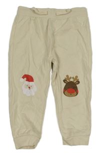 Béžové tepláky se sobem a Santou