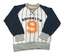 Bílo-tmavomodrá mikina s číslem a pruhy