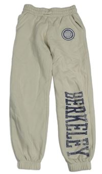 Světlebéžové tepláky se znakem a nápisem 