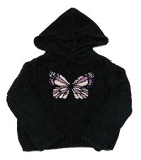 Černý melírovaný žinylkový svetr s motýlkem z překlápěcích flitrů a kapucí dopodopo