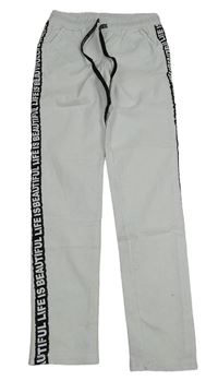 Bílo-černé skinny kalhoty s nápisy 