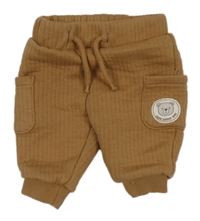 Hnědé žebrované tepláky s kapsami a medvědem zn. Dopodopo