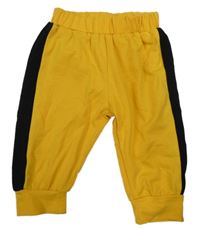 Tmavožluto-černé tepláky