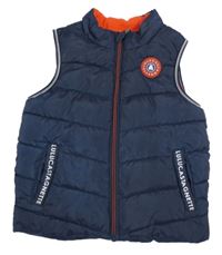Tmavomodrá prošívaná šusťáková zateplená vesta s nášivkou  
