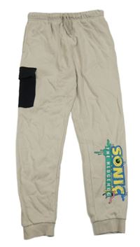 Světlebéžové tepláky s nápisem - Sonic a kapsou George