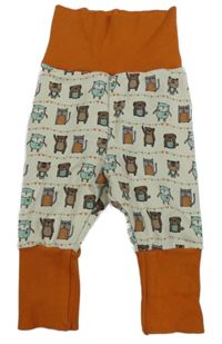 Bílo-oranžové tepláky se zvířátky