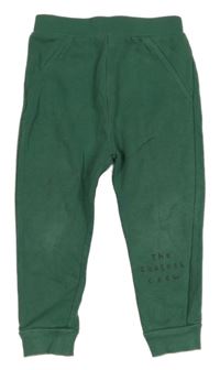 Tmavozelené tepláky s nápisem George 