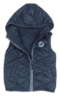 Tmavomodrá prošívaná šusťáková zateplená vesta s dinosaurem a kapucí St. Bernard