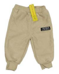 Nové - Béžové fleecové zateplené tepláky s nášivkou Shein