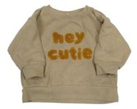 Béžový svetr s nápisem