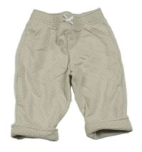 Světlebéžovošedé puntíkaté tepláky s mašličkou CYRILLUS