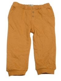 Oranžové tepláky s knoflíky 