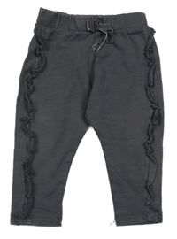 Tmavošedé tepláky s volánky hema