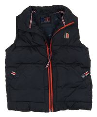 Tmavomodrá prošívaná šusťáková zateplená vesta s nášivkou Next