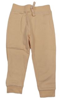 Meruňkové tepláky s nápisem Dunnes