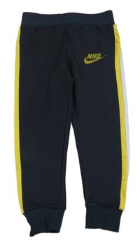 Tmavomodré sportovní tepláky s pruhem 