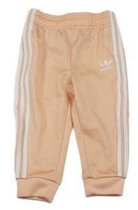 Světlerůžovo-bílé sportovní tepláky s pruhy Adidas