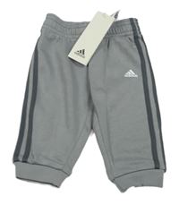 Nové - šedé tepláky s pruhy a logem Adidas