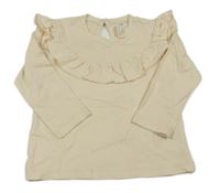 Smetanové triko s volánkem zn. H&M