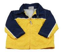 Hořčicovo-tmavomodrá šusťáková jarní bunda